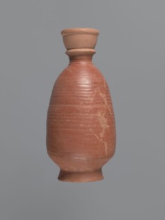 Bottle, unknown Aswan workshop; baggy-shaped bottle without preserved spout. The neck widens toward