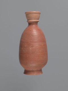 Bottle, unknown Aswan workshop; baggy-shaped bottle without preserved spout. Neck widens toward the