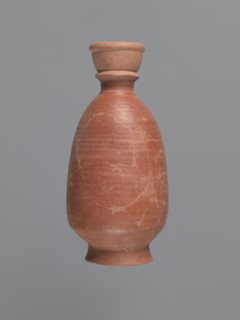 Bottle, unknown Aswan workshop; baggy-shaped bottle without a preserved spout. The neck widens