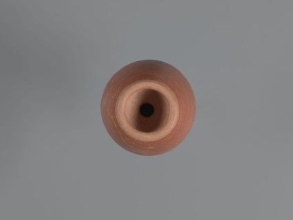 Bottle, unknown Aswan workshop; baggy-shaped bottle without a preserved spout. The neck widens