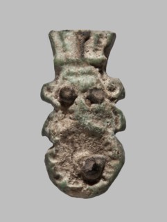 Amulet — single-sided tile with a schematic relief representation of Bes: a head with a feathered