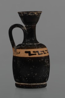 Black-finned aryballois lekythos. Large, ring-shaped foot. The body is rather squat, barrel-shaped