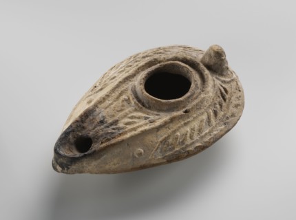Oil lamp, unknown Palestinian workshop. Oval lamp with conical handle. Large olive opening
