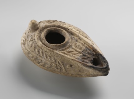 Oil lamp, unknown Palestinian workshop. Oval lamp with conical handle. Large olive opening