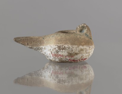 Oil lamp, 12th century, Iran. Ceramic utility oil lamp with a round container with a flattened