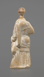 Terracotta figurine of a standing woman. Terracotta, molded figurine; 4th century BC, Tanagra