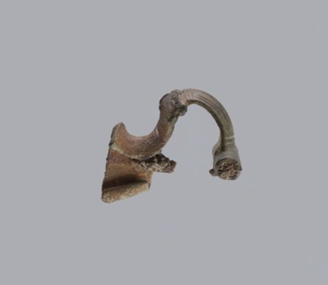 Brooch with a crossbar. Brooch with a bow made of a wide, slightly curved band decorated with