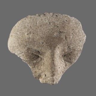 Fragment of a stucco mask; upper part of a sarcophagus mask showing forehead, eyes and nose.