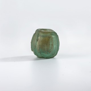 Bottle, Islamic, Persian; blue-green glass bottle decorated with small almond-shaped ovals in an