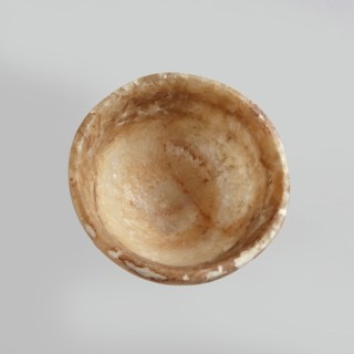 Bowl made of striped, coarse-crystalline Egyptian alabaster, waxed, with a flat bottom and gently