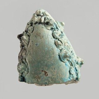 Fragment of a votive boat. Prow or stern with decoration in the form of glued appliqués. On the