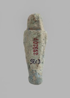 Ushabti. Carelessly made figurine with schematic facial features, in a narrow wig revealing the