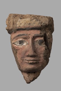 Sarcophagus mask with a partially preserved fragment of a wig above the forehead painted yellow