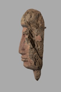 Sarcophagus mask with a partially preserved fragment of a wig above the forehead painted yellow