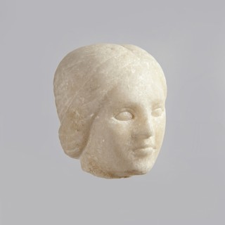 Fragment of a female figurine. Fragment of a small-sized sculpture or sculptural group. The