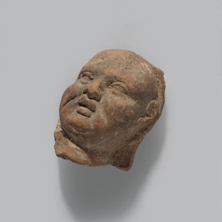 Harpocrates; fragment of a terracotta figurine head of Harpocrates; Hellenistic or Roman period,