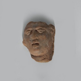 Fragment of the head of a terracotta female figurine. Fragmentarily preserved head depicting a