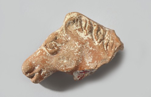 Head of a terracotta horse figurine. Terracotta head with part of the neck and mane of a horse. The