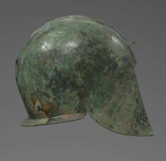 Bronze helmet with rectilinear cutouts for the eyes, nose, mouth, and chin; two prominent