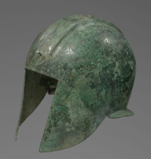 Bronze helmet with rectilinear cutouts for the eyes, nose, mouth, and chin; two prominent