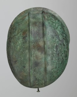 Bronze helmet with rectilinear cutouts for the eyes, nose, mouth, and chin; the helmet has two