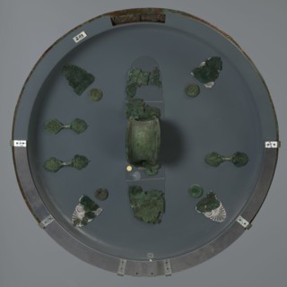 Hoplite shield, 6th century BC, Italy, weaponry, A round display with a muted gray background holds