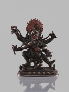 Six-armed Mahakala, dharmapala; Tibetan Buddhist sculpture, 19th century, carved figure on a lotus