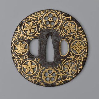Round tsuba maru gata of the mon-sukashi type, decorated with eight openwork coats of arms monami