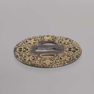 Crossguard tsuba, sword crossguard of maru gata round tsuba mon-sukashi type, decorated with eight