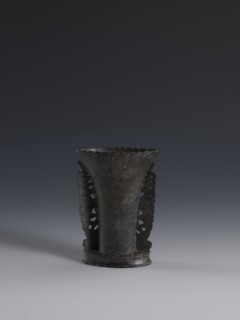 Vase, made of dark soapstone with bas-relief and openwork in places; plant ornament. One of three.