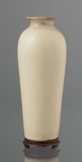 Cylindrical porcelain vase tapering toward the bottom with a flat rim; light cream glaze with fine