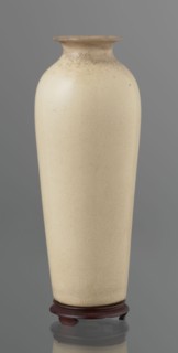 Cylindrical porcelain vase tapering toward the bottom with a flat rim; light cream glaze with fine