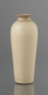 Cylindrical porcelain vase, tapering towards the bottom; flat rim. Light cream glaze with fine