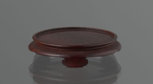 Vase on saucer. Cylindrical porcelain vase tapering toward the bottom with a flat rim; light cream