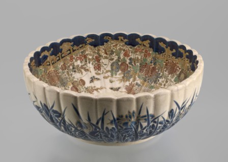 Deep bowl on a low ring-shaped base with a knobbed body and serrated rim, reminiscent of a