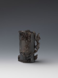 Vase on base, carved ornaments of flowers, birds, and stylized rocks; wooden oval base on three