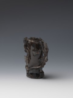 Vase on base, carved ornaments; wooden base, oval on three legs. Carved decoration: stylized rocks,