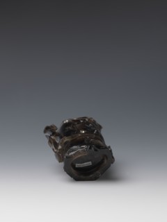 Vase on base, carved ornaments of flowers, birds, and stylized rocks; wooden oval base on three
