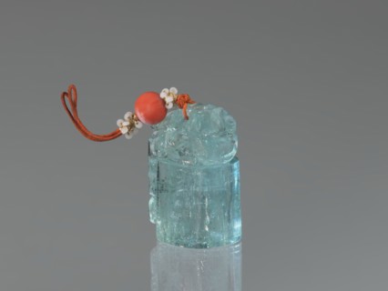 Seal stamp pendant, carved aquamarine stone, polished in the upper part; depicts a lion; strung