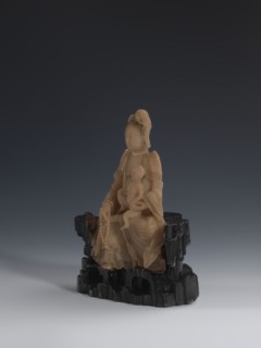 Guanyin Giving Birth to a Son on a Rock; sculptor unknown. Figurine of the goddess made of light