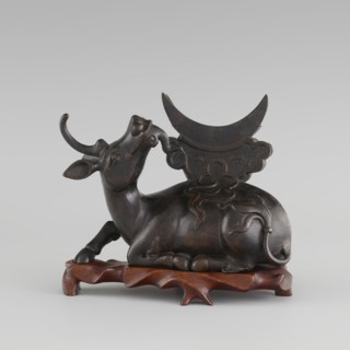Mirror with TLV decoration on a pedestal in the form of a qilin on a base. Chinese, Qing dynasty