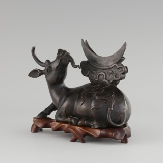 Mirror with TLV decoration on a pedestal in the form of a qilin on a base; Chinese, Qing dynasty