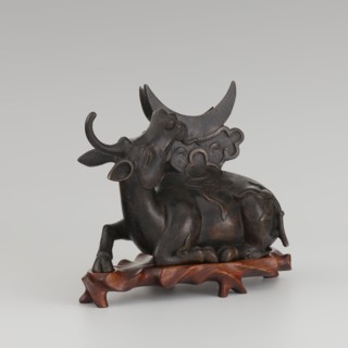 Mirror with TLV decoration on a pedestal in the form of a qilin on a base. Chinese; Qing dynasty
