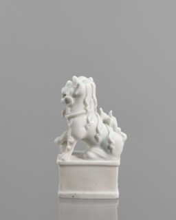Fo lion foo dog figurine with a ball; maker, 18th century China; blanc de Chine porcelain; subject: