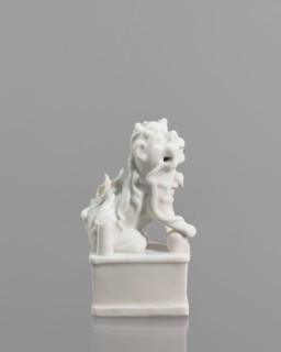 Fo lion figurine with a ball;, lion iconography; blanc de Chine porcelain; animal figurine; Chinese