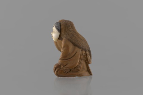 Netsuke in the shape of a nô theater actor wearing an Okame mask, Hôjitsu fl. ca. 1800–1860