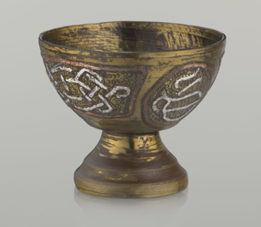 Bowl, decorated with braid and stylized Arabic inscriptions in cartouches on a punched background;