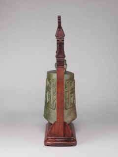 Bell on a wooden stand in the shape of a paifang gate, gilded mount for hanging the bell. Bronze