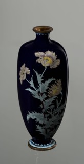 Angular vase one of a pair with rounded edges, on a low round foot and with a short neck slightly