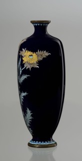 Angular vase one of a pair with rounded edges, on a low round foot and with a short neck slightly